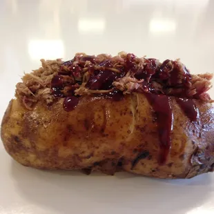 a baked potato covered in cranberry sauce