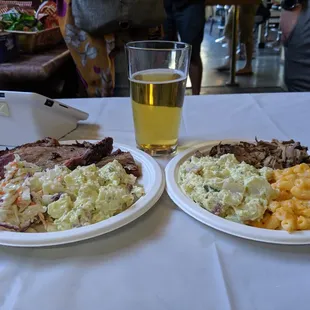 two plates of food and a glass of beer