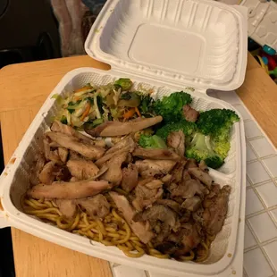 a chicken and broccoli meal in a styrofoam container