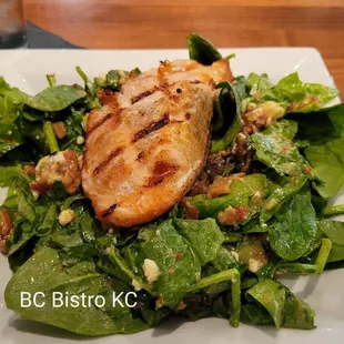 Spinach salad topped with Salmon