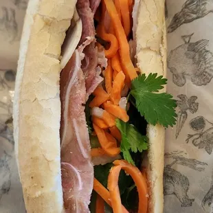 a sub sandwich with meat and vegetables
