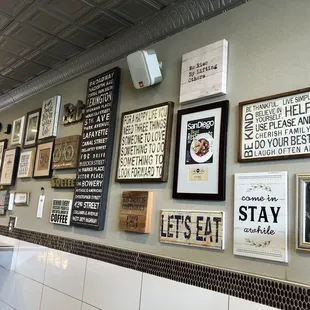 a wall of framed signs