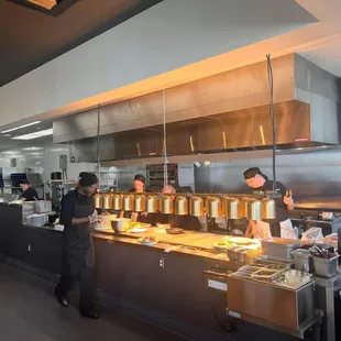 a group of people in a restaurant kitchen
