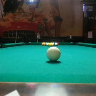 Shooting pool.