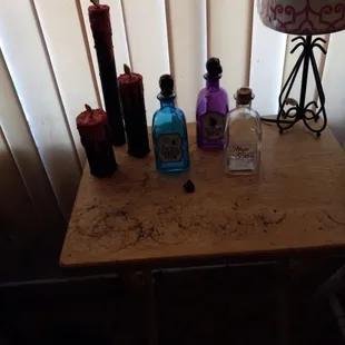 Handmade Halloween black candles and witches brew glass bottles. Assorted potions and more.