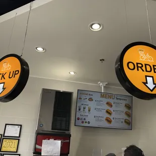 Signs designate where customers can place an order and pick up their food.