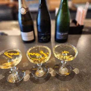 three glasses of wine and a plate of cheese