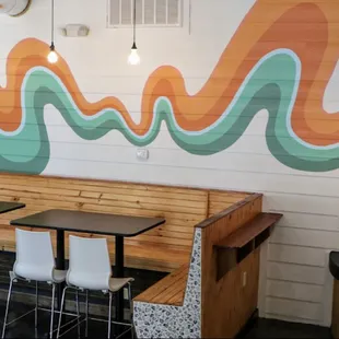 a colorful mural on the wall of a coffee shop