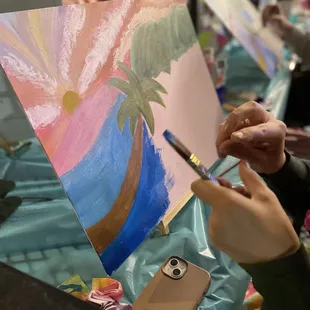 Pictured is a patron working out their ocean line at the "Life's a Beach" paint party.