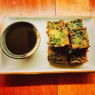 Chives Pancake: Pan-fried rice pancake, fresh chives, served with sweet soy sauce