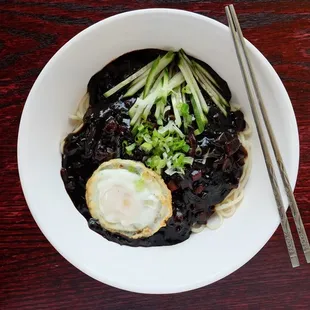 a bowl of food with chopsticks