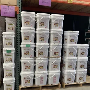 a large stack of buckets of food