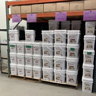 a large stack of buckets of food