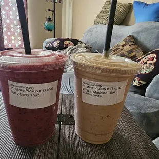 two smoothie beverages on a table