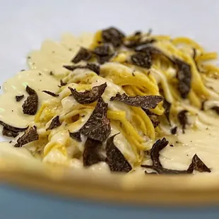 Tajarin Al Tartufo: Hand cut pasta, parmesan fonduta, black périgord truffles | $48