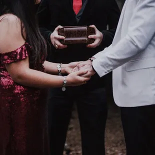 The bride and groom&apos;s hands joined together in ceremony