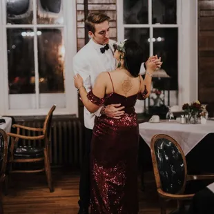 Bride in red dress dancing with Groom in white tux at the haunted Crescent Hotel