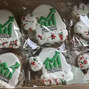 a dozen decorated cookies in a box