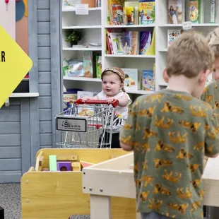 Grocery shopping at the pretend grocery store.