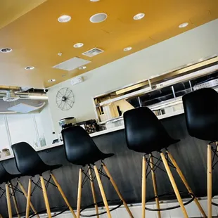 Lots of tables and stools at the counter