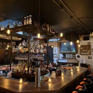 a bar with a lot of bottles on the shelves