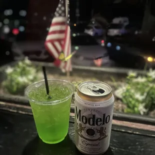 a can of modelo next to a drink