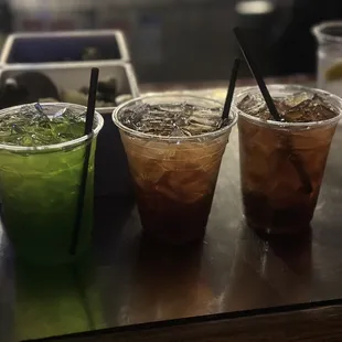 three different drinks on a table