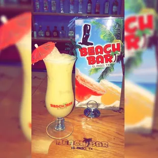 a drink and a book on a table