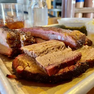 Three meat plate with pork belly up front, brisket to the left and spare ribs to the right.