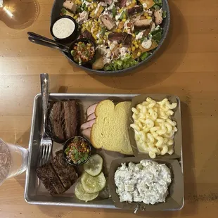 3 meat plate with brisket, pork belly, and turkey. Mac and cheese and baked potato salad for the sides