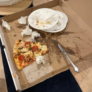 a half eaten pizza in a box