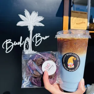 a hand holding a cup of iced coffee