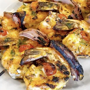 a plate of grilled shrimp skewers