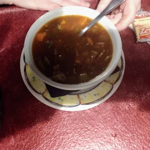 a bowl of soup with a spoon