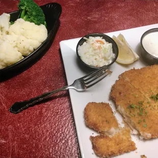 a plate of fish, mashed potatoes, and broccoli