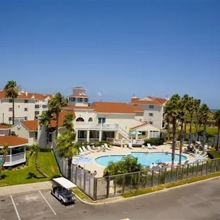 Looking north over pool, clubhouse (centre), gazebo (left) and condo unit by Whitecap Boulevard.