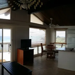 Open space floorplan for the kitchen, living room, and small dining table. Open beams!! :)