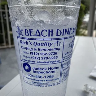 a glass of water with a straw in it