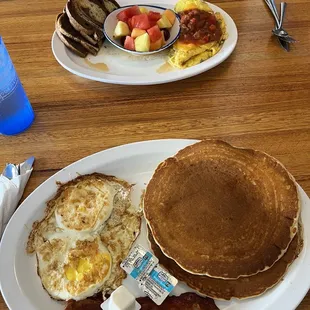 Short stack pancakes with eggs over hard and bacon