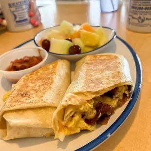 a breakfast burrito with a side of fruit