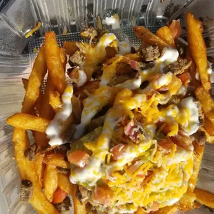 a container of fries and cheese