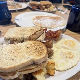 Two eggs, home fries, bacon, sausage, pancake, and toast $8.75