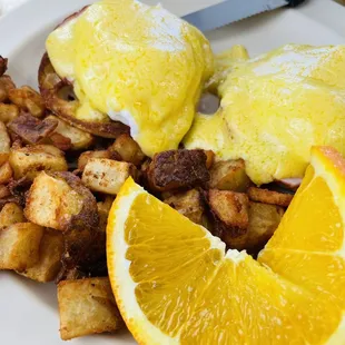 Eggs Benedict with crispy home fries.