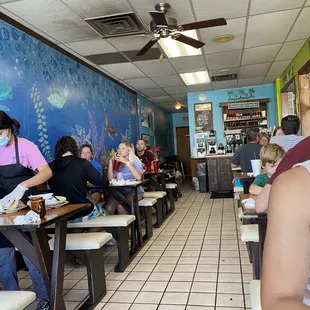 people sitting at tables with masks on