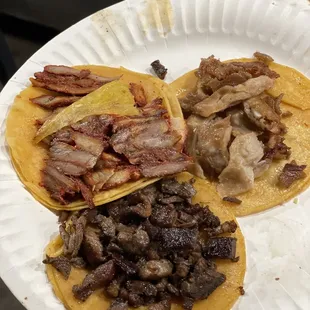 a plate of tacos with meat and beans