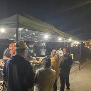 a group of people at a food stand