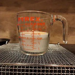 Baked beans in container, in measuring cup. Scooped out, just over 1/2 cup.