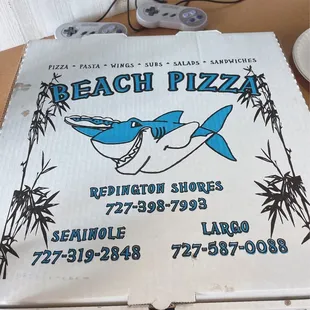 a pizza box with a shark on it
