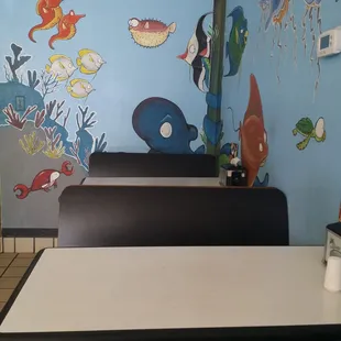 3 small booths and 2 small tables inside.