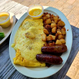 Seafood omelette, stuffed w shrimp, scallops, lump crab meat and cheddar, covered in hollandaise. Extra crispy home fries and sausage.